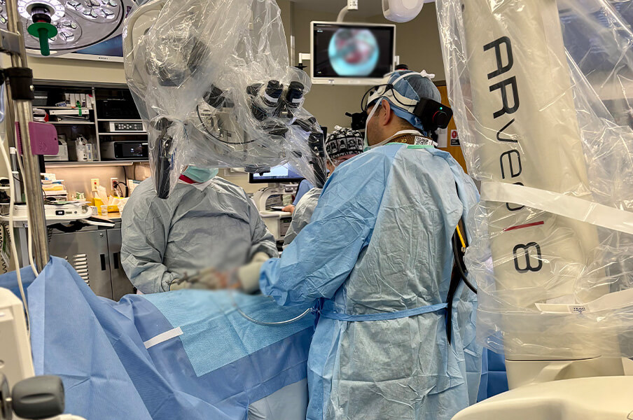 Dr. Karsy and Dr. Yaghi using the neurosurgery MyVeo headset microscopes 