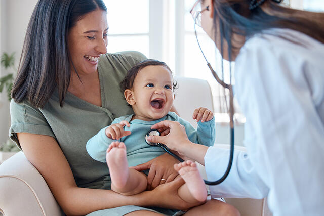Mother and baby with physician and stethoscope