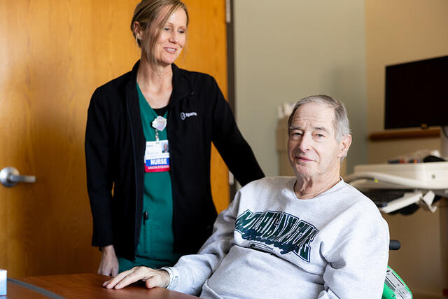 Mary Free Bed Carousel - Man at Table with Nurse