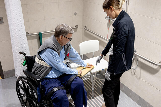 Mary Free Bed Carousel - Man in Wheelchair in Shower getting Physical Therapy