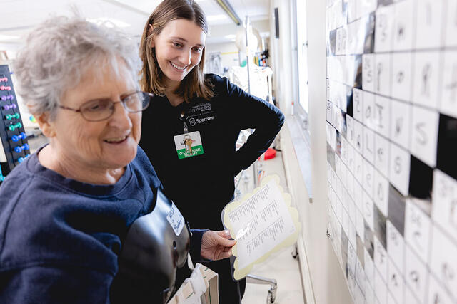 Mary Free Bed Carousel - Woman Spelling with Physical Therapist