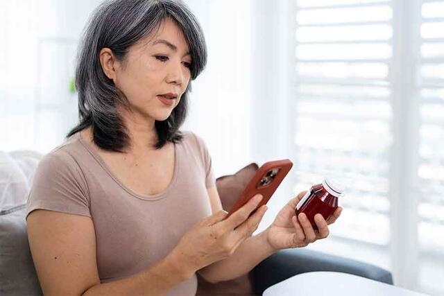 Woman scanning QR Code on Prescription Bottle | 900x600px