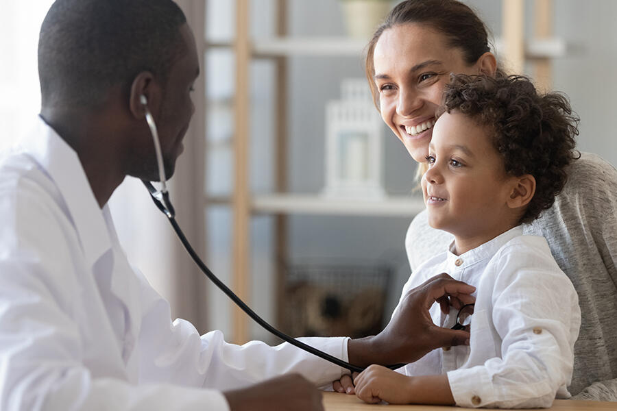 Physician with mom and child and stethoscope